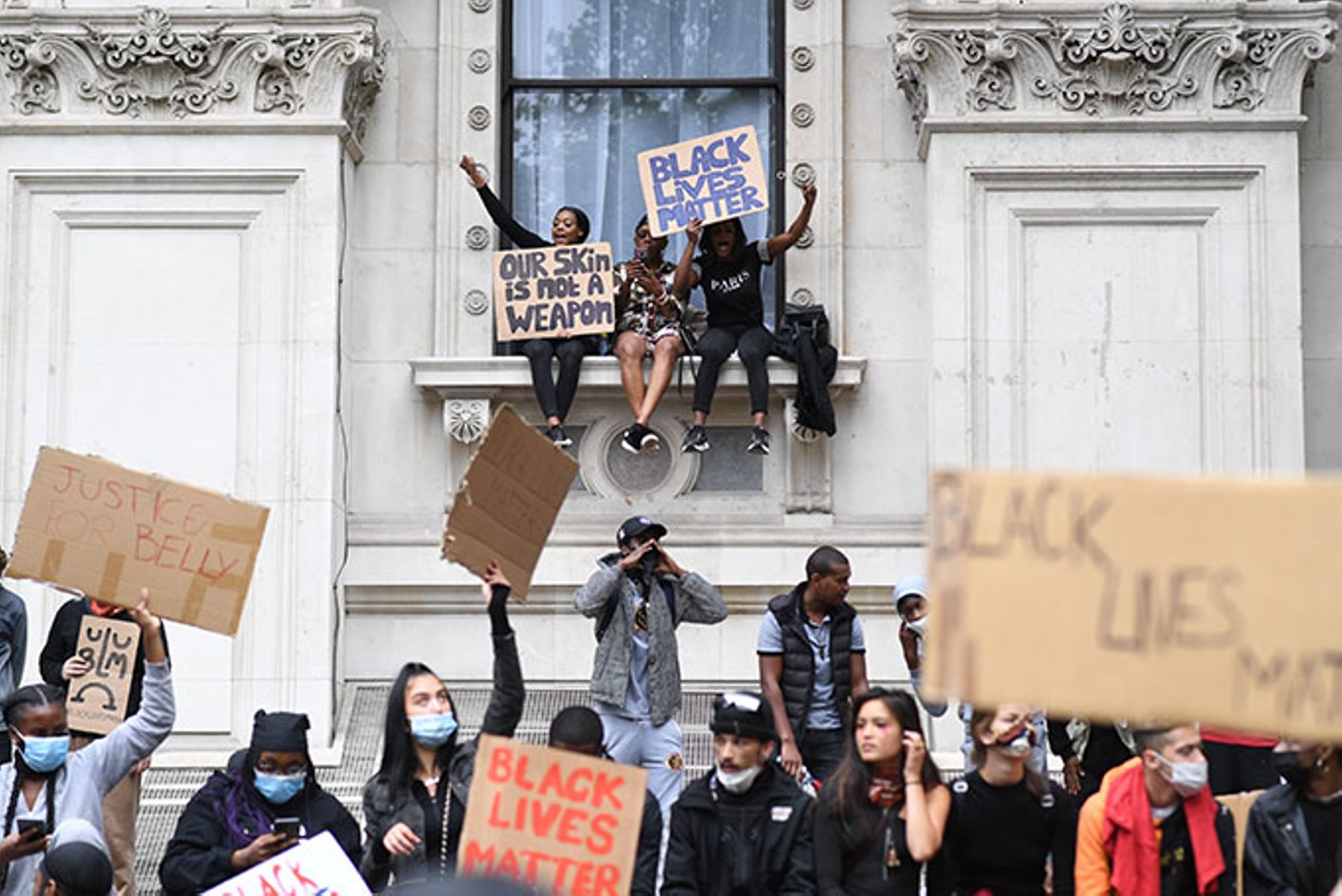 People participate in a Black Lives Matter protest rally outside the Foreign and Commonwealth Office, London.