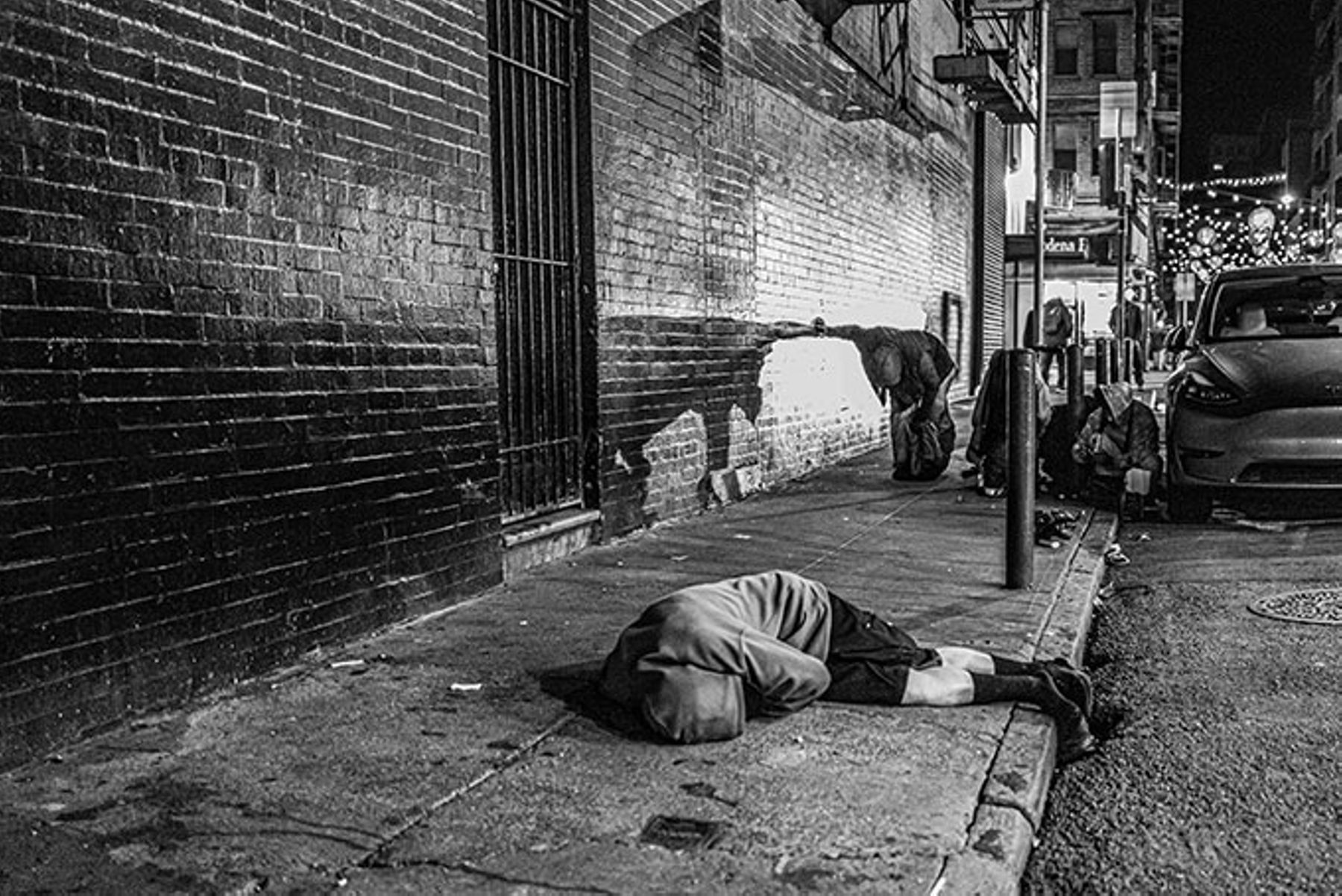 A man sleeping on the street in San Francisco's Tenderloin neighborhood.