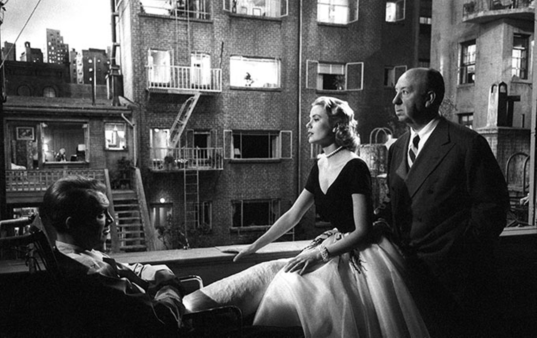 Actors Grace Kelly and Jimmy Stewart with Alfred Hitchcock on the set of Rear Window.