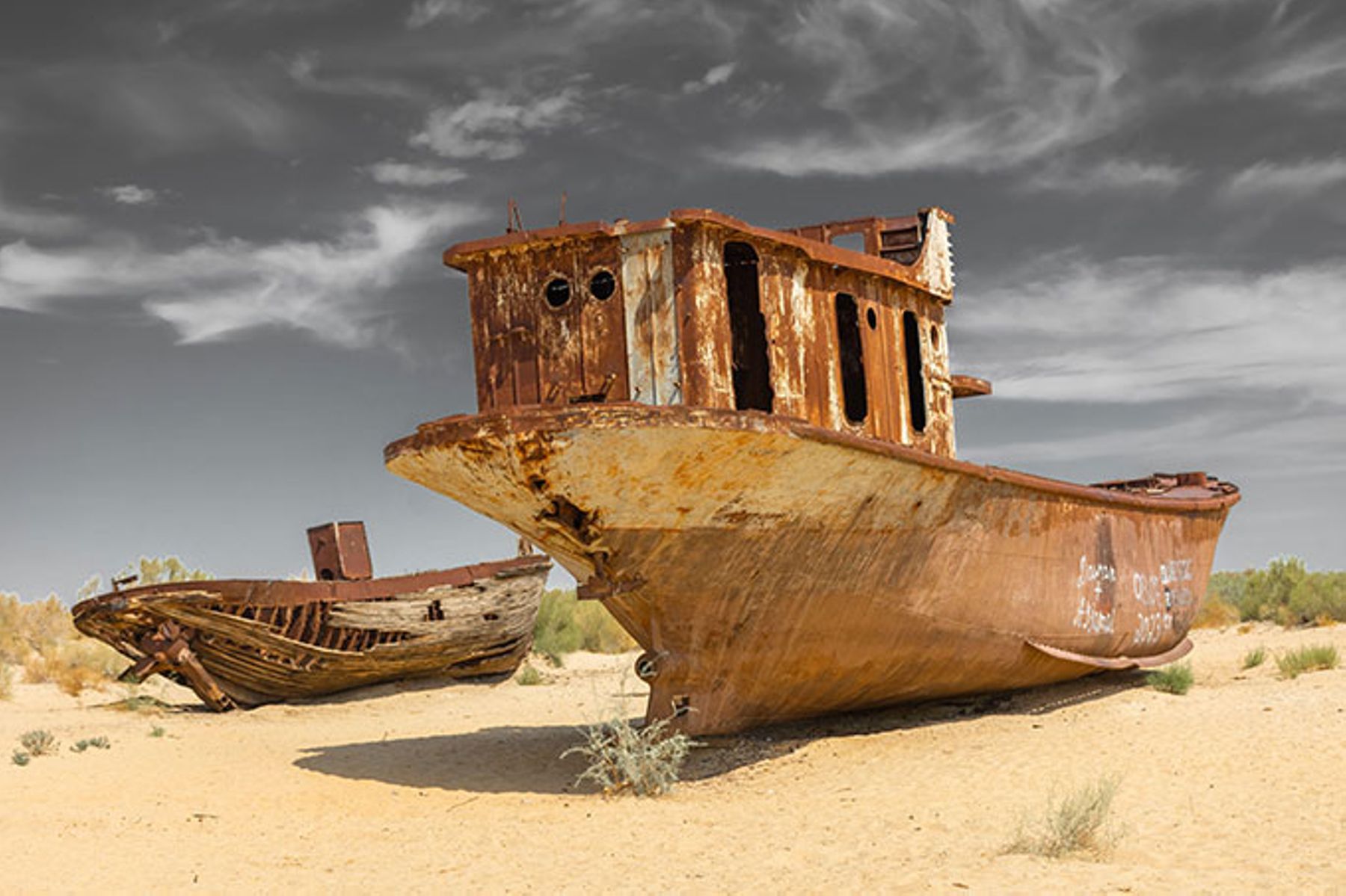 Rusted shipwrecks in the Aral Sea drained by Soviet-era irrigation schemes.