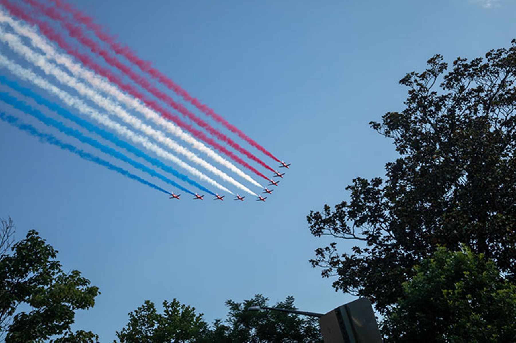 Jets trailing red, white, and blue, fly over Washington on the first day of the Great American State Fair.
