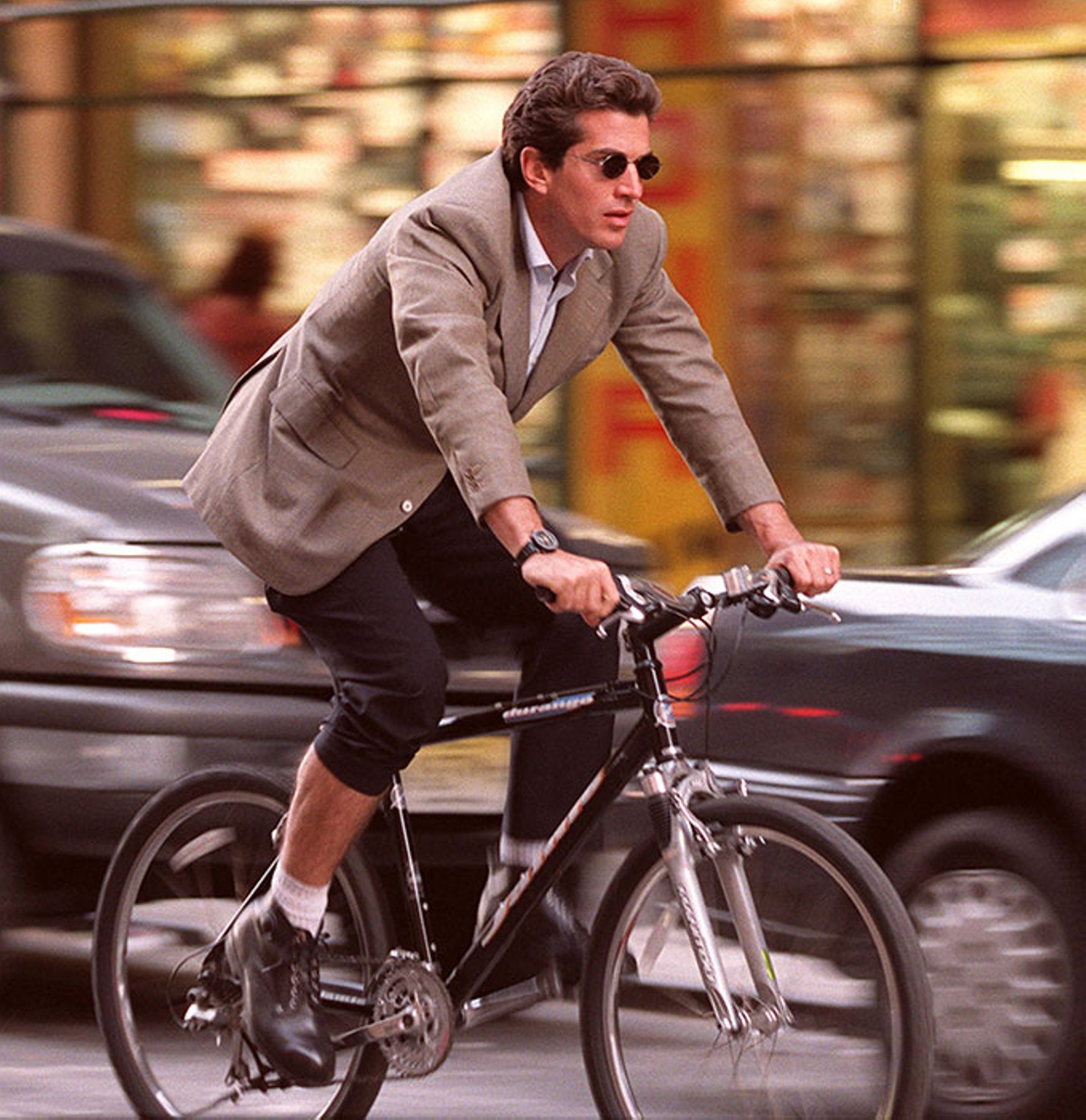 John Kennedy, Jr. bicycles on 7th avenue and 56th street thru rush hour traffic, 1998.