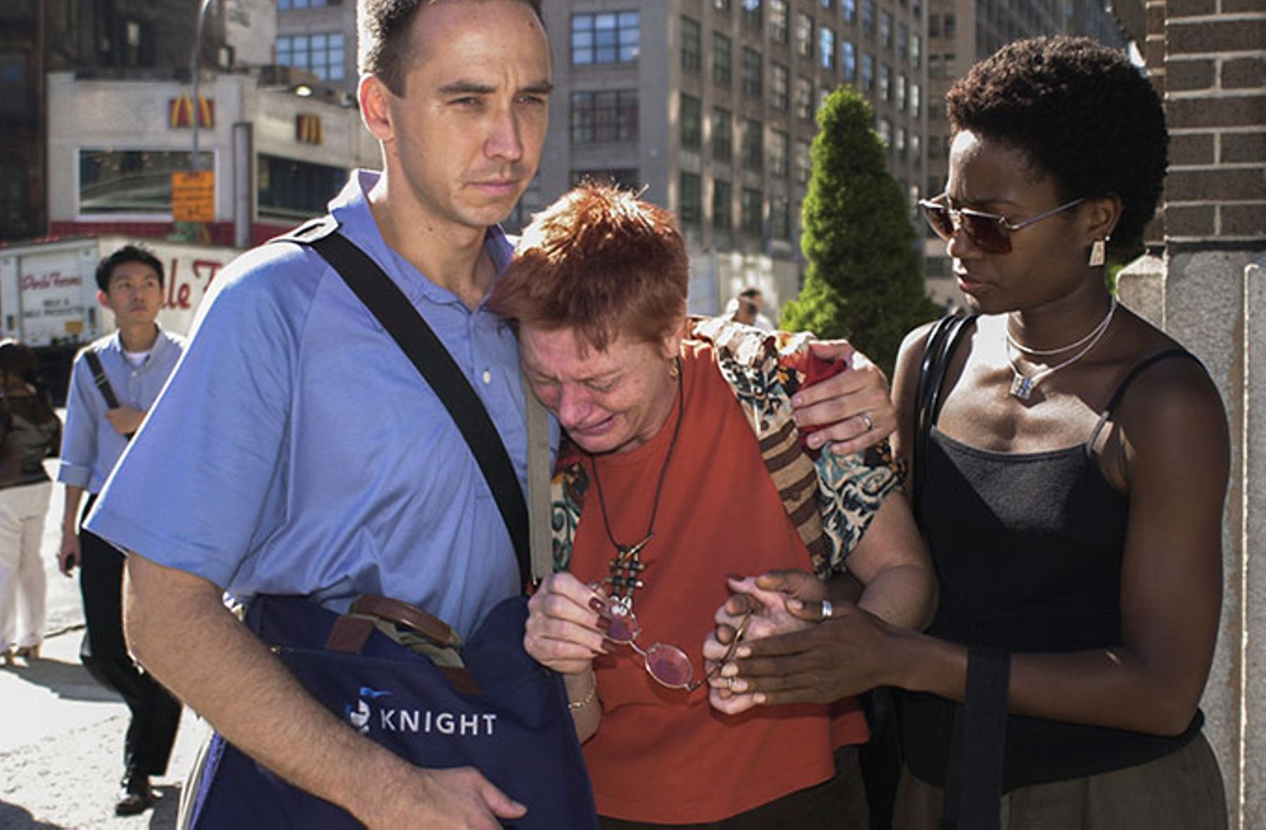 People comfort one another during the terrorist attack on The World Trade Center on Sept. 11, 2001.