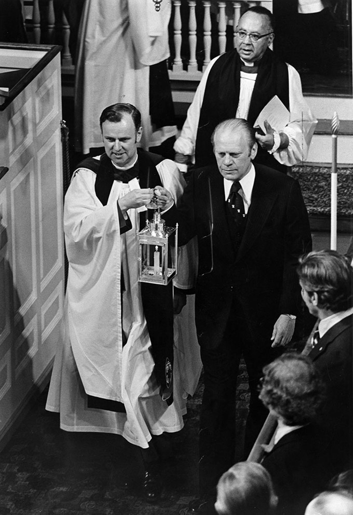 President Gerald Ford and Vicar Robert W. Golledge light the third lantern to be hung in the Old North Church 1975.