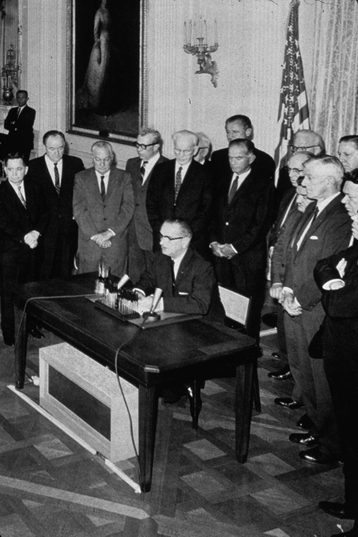 President Lyndon Johnson signs the Gulf of Tonkin Resolution in 1964.