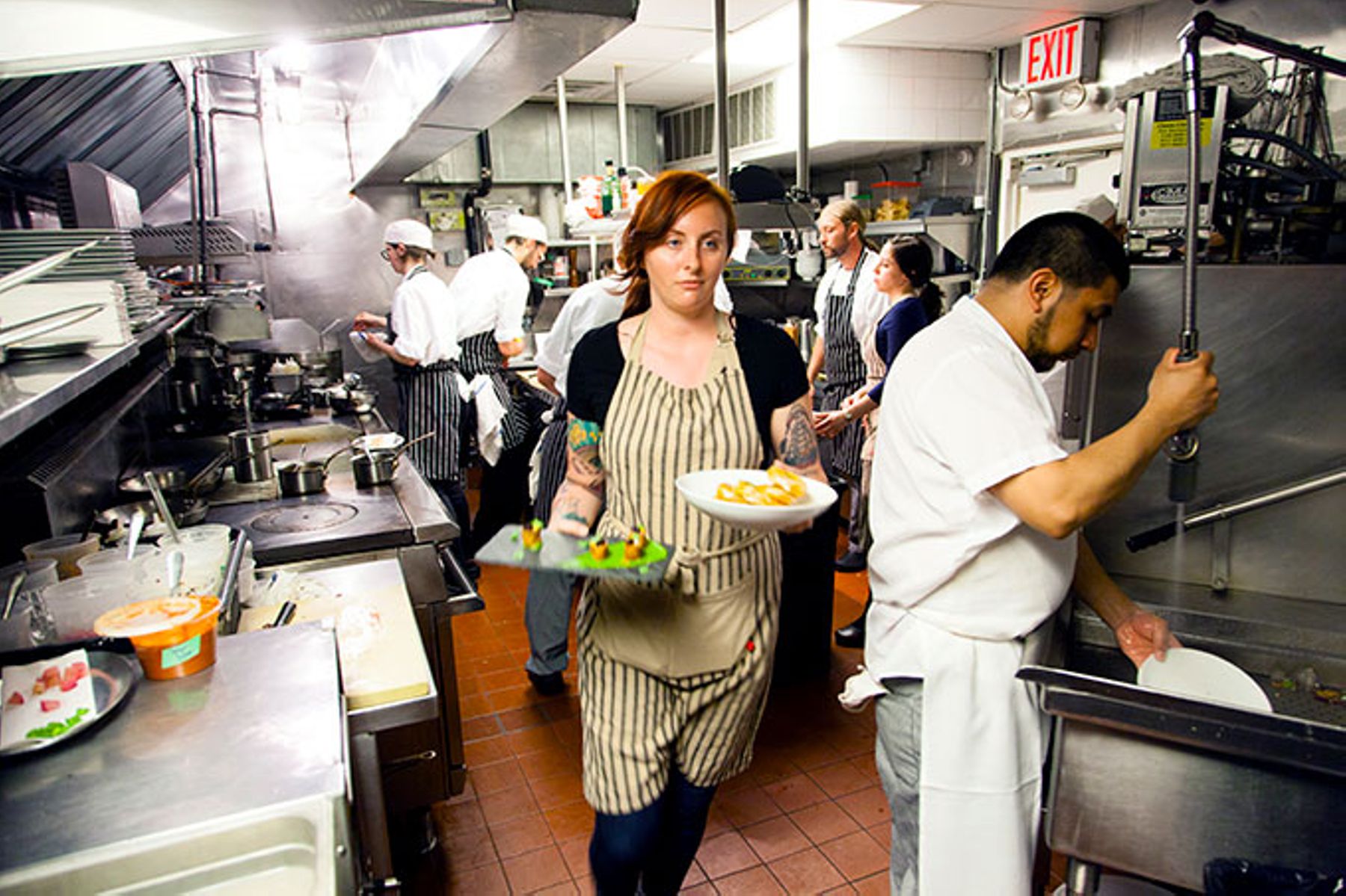 Busy back of house of restaurant.